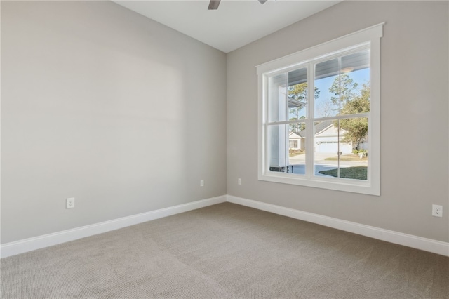 spare room featuring baseboards, carpet, and a ceiling fan