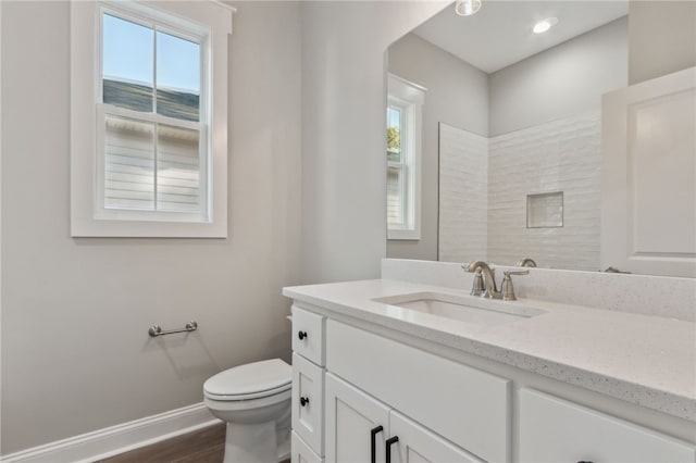 full bath featuring baseboards, toilet, wood finished floors, and vanity