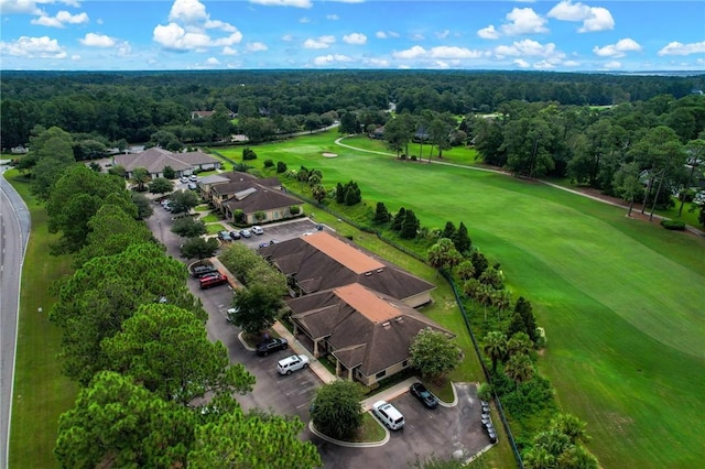 birds eye view of property featuring golf course view and a wooded view