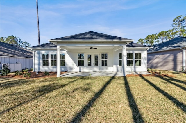 rear view of property with a patio area, a lawn, and ceiling fan