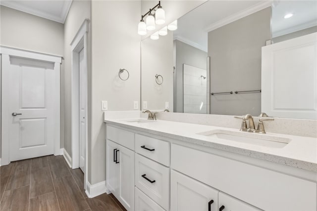 full bathroom with a sink, wood finish floors, ornamental molding, and double vanity