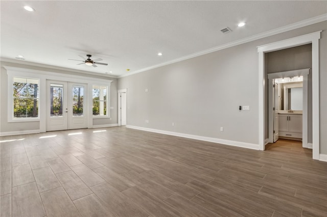 unfurnished living room featuring wood finish floors, baseboards, visible vents, and ceiling fan