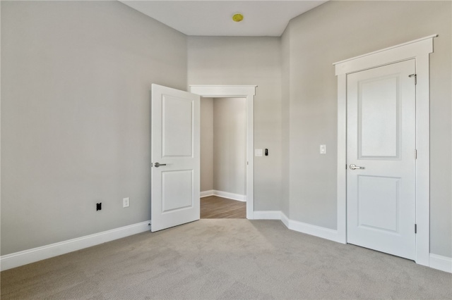 unfurnished bedroom with baseboards and carpet flooring