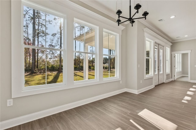 unfurnished sunroom featuring an inviting chandelier, a healthy amount of sunlight, and visible vents