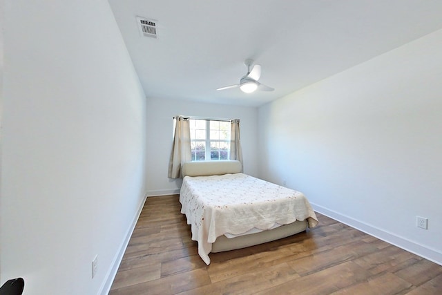 1625 Windsor Dr, Waycross, GA 31501 - bedroom featuring baseboards, wood finished floors, visible vents, and a ceiling fan