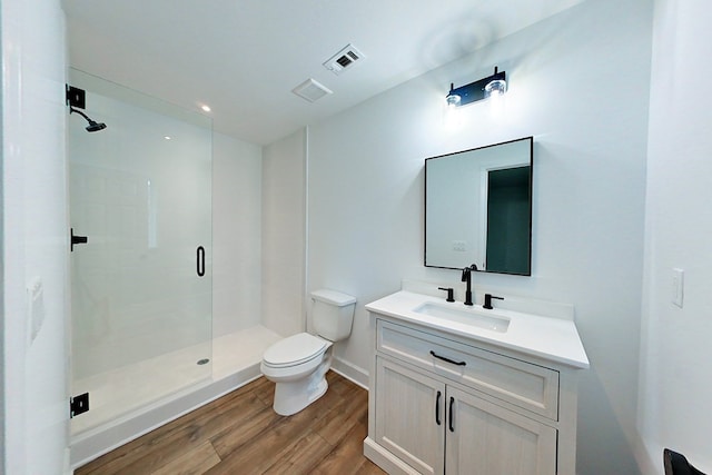 1625 Windsor Dr, Waycross, GA 31501 - bathroom with wood finished floors, visible vents, a shower stall, and toilet