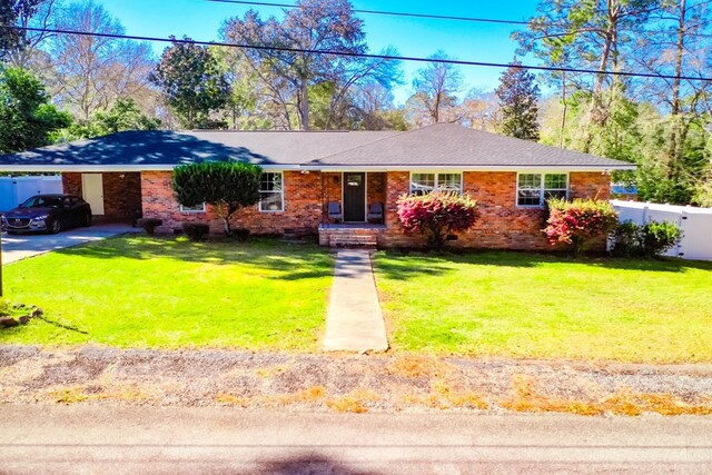 1625 Windsor Dr, Waycross, GA 31501 - ranch-style home with driveway, fence, an attached carport, a front yard, and brick siding