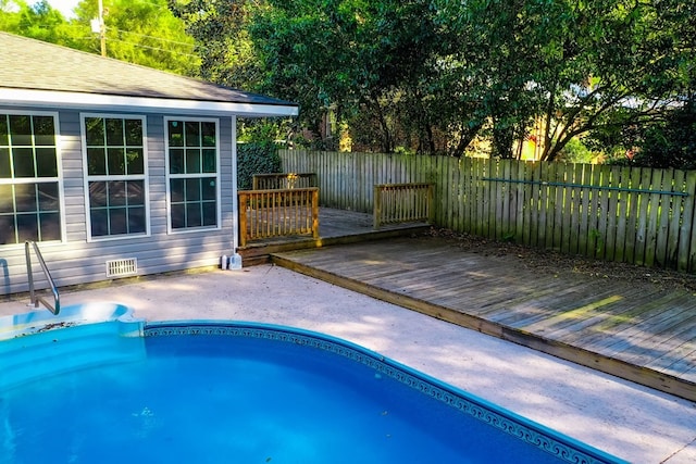 1625 Windsor Dr, Waycross, GA 31501 - view of swimming pool with a wooden deck, a fenced backyard, and a fenced in pool