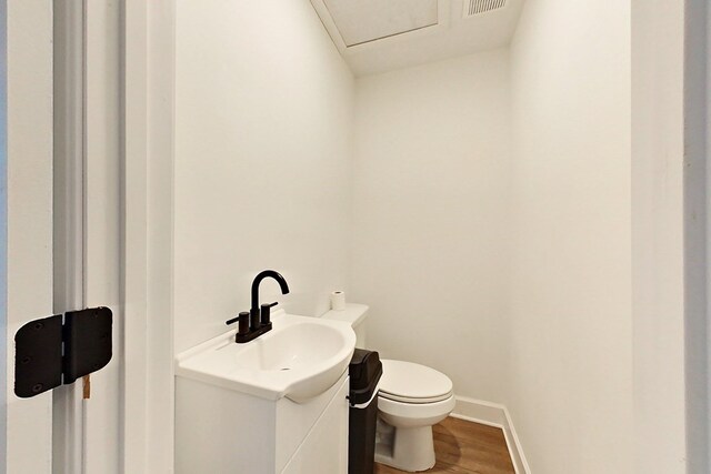 1625 Windsor Dr, Waycross, GA 31501 - half bath with baseboards, wood finished floors, vanity, and toilet