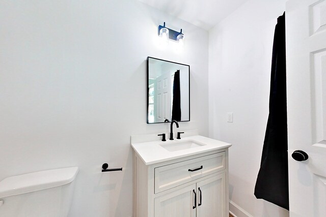 1625 Windsor Dr, Waycross, GA 31501 - half bath featuring toilet, vanity, and baseboards