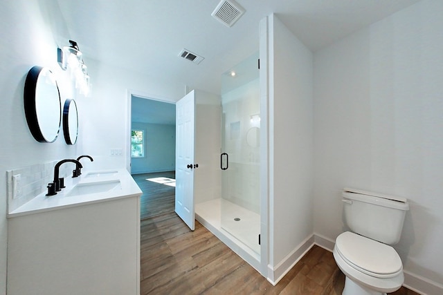 1625 Windsor Dr, Waycross, GA 31501 - bathroom featuring toilet, wood finished floors, a sink, and visible vents
