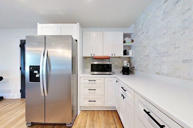 1625 Windsor Dr, Waycross, GA 31501 - kitchen with light wood finished floors, stainless steel appliances, open shelves, and white cabinets