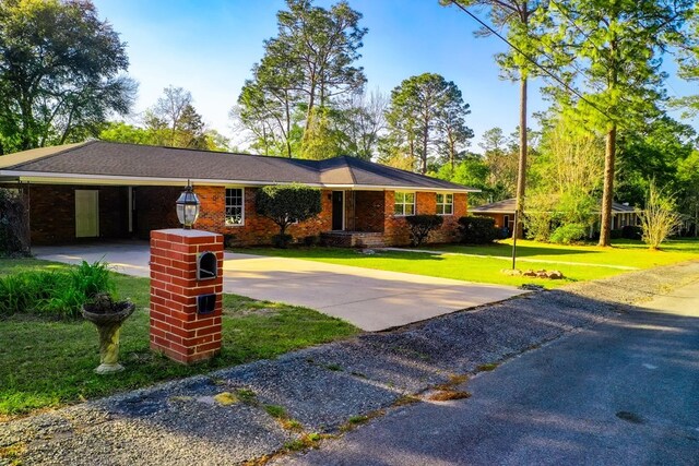 1625 Windsor Dr, Waycross, GA 31501 - single story home with a carport, brick siding, a front yard, and concrete driveway