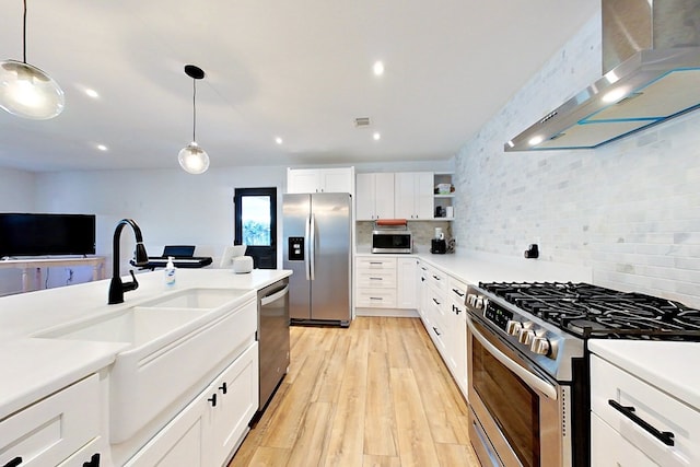 1625 Windsor Dr, Waycross, GA 31501 - kitchen with stainless steel appliances, white cabinetry, and wall chimney range hood