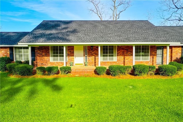 2227 Ware St, Blackshear, GA 31516 - view of front of home with a front yard, roof with shingles, and brick siding