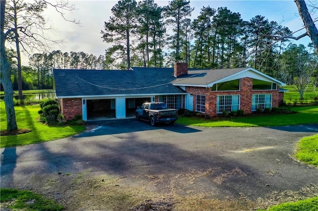 2227 Ware St, Blackshear, GA 31516 - ranch-style home featuring asphalt driveway, a chimney, brick siding, and a front yard