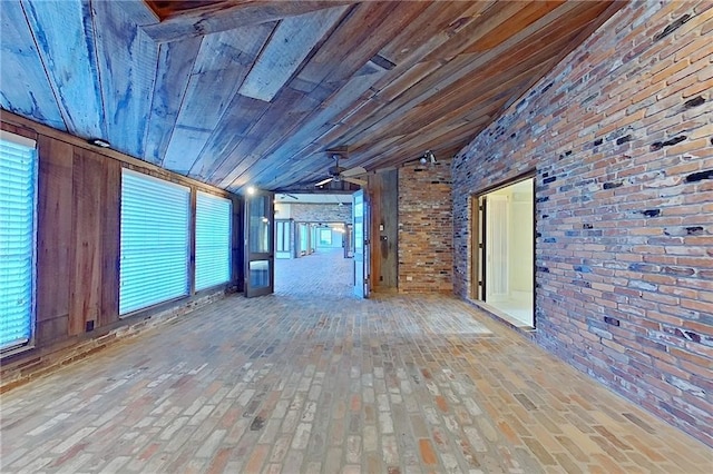 2227 Ware St, Blackshear, GA 31516 - spare room featuring ceiling fan, brick floors, brick wall, and healthy amount of natural light