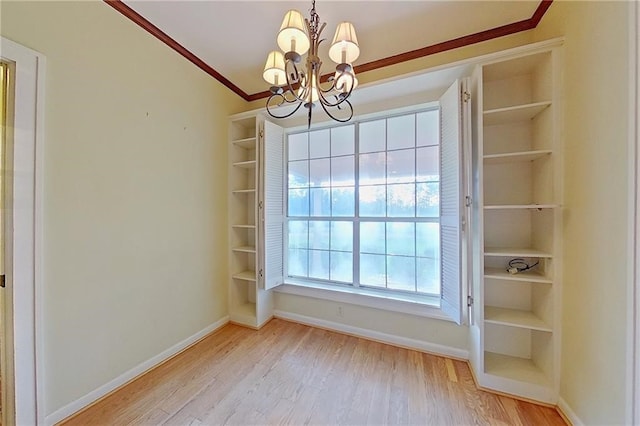 2227 Ware St, Blackshear, GA 31516 - unfurnished dining area with a chandelier, light wood-style floors, baseboards, and crown molding