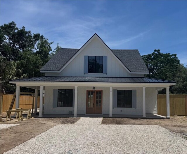 1912 First Ave, Saint Simons Island, GA 31522 - view of front of property featuring a standing seam roof, roof with shingles, and a porch