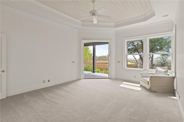 interior space featuring crown molding, ceiling fan, carpet, baseboards, and a raised ceiling
