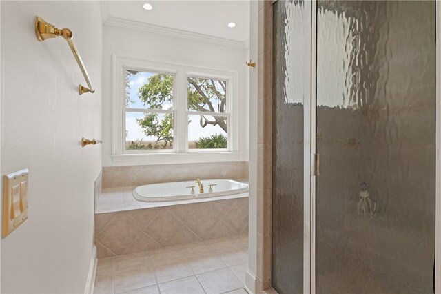bathroom featuring crown molding, tile patterned floors, a garden tub, and a stall shower