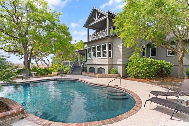 pool with stairway and a patio area