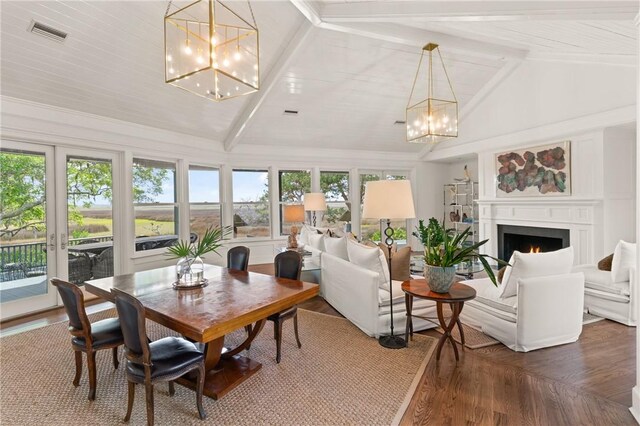 sunroom with visible vents, beam ceiling, and a notable chandelier