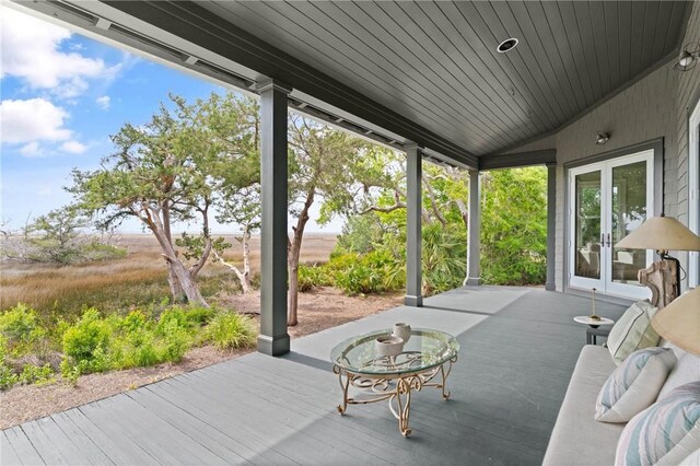 sunroom featuring lofted ceiling, french doors, and wood ceiling