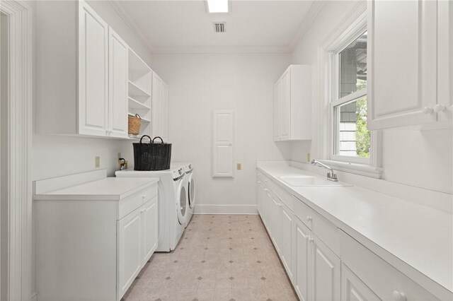 laundry room featuring a sink, separate washer and dryer, light floors, cabinet space, and visible vents