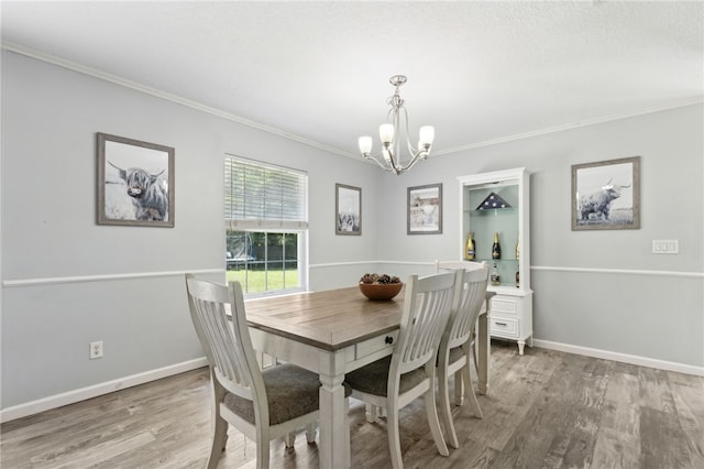 107 Tori Dr, Saint Marys, GA 31558 - dining room with a chandelier, ornamental molding, light wood finished floors, and baseboards