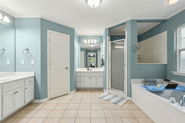 107 Tori Dr, Saint Marys, GA 31558 - bathroom with crown molding, a stall shower, tile patterned flooring, baseboards, and two vanities