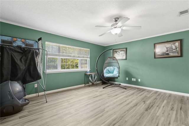 107 Tori Dr, Saint Marys, GA 31558 - bedroom featuring a textured ceiling, wood finished floors, crown molding, baseboards, and a ceiling fan