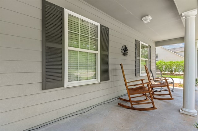 107 Tori Dr, Saint Marys, GA 31558 - new england style home with concrete driveway, a porch, and an attached garage