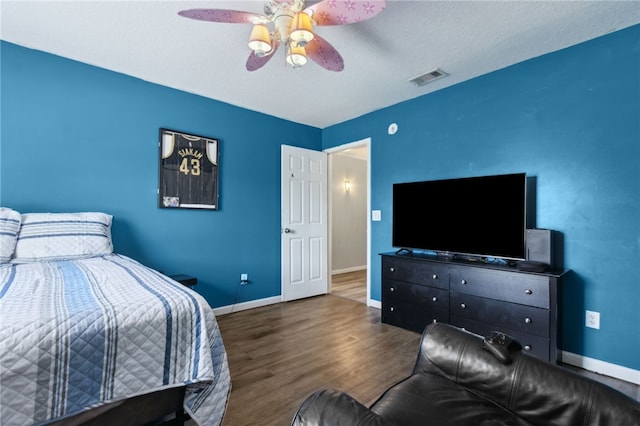 107 Tori Dr, Saint Marys, GA 31558 - bedroom featuring wood finished floors, baseboards, a ceiling fan, and a textured ceiling