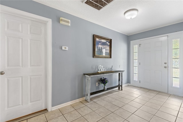107 Tori Dr, Saint Marys, GA 31558 - entrance foyer with light tile patterned flooring, crown molding, baseboards, and a textured ceiling