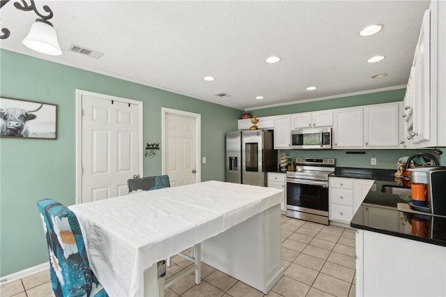 107 Tori Dr, Saint Marys, GA 31558 - kitchen featuring appliances with stainless steel finishes, a sink, white cabinetry, light tile patterned flooring, and recessed lighting