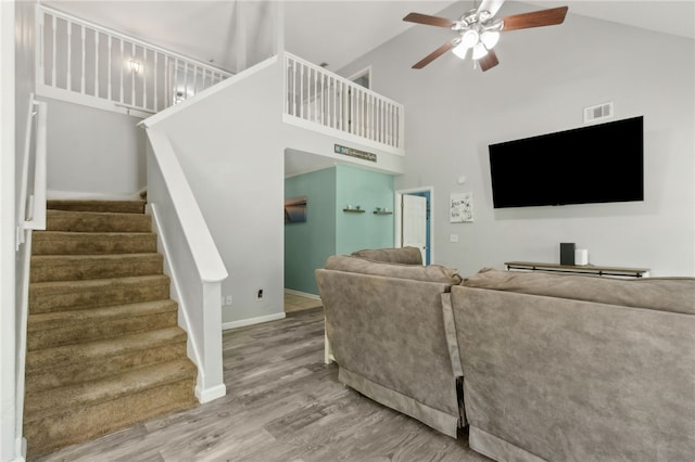107 Tori Dr, Saint Marys, GA 31558 - living room with high vaulted ceiling, ceiling fan, wood finished floors, stairs, and baseboards