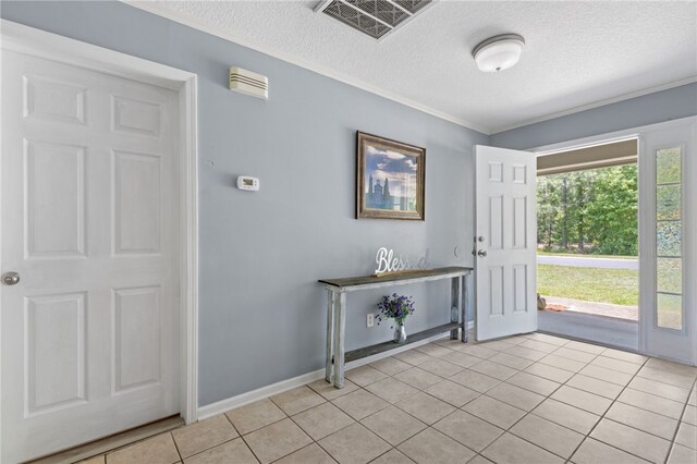 107 Tori Dr, Saint Marys, GA 31558 - entrance foyer featuring a textured ceiling, light tile patterned floors, crown molding, and baseboards