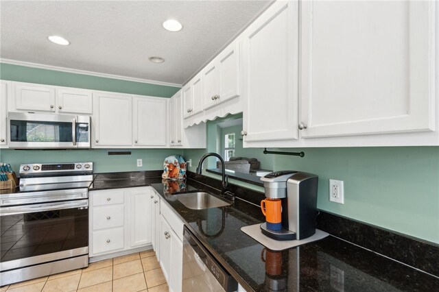 107 Tori Dr, Saint Marys, GA 31558 - kitchen featuring stainless steel appliances, a sink, white cabinets, dark stone counters, and recessed lighting