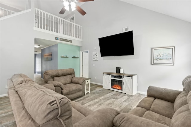 107 Tori Dr, Saint Marys, GA 31558 - living area featuring high vaulted ceiling, ceiling fan, wood finished floors, baseboards, and a glass covered fireplace