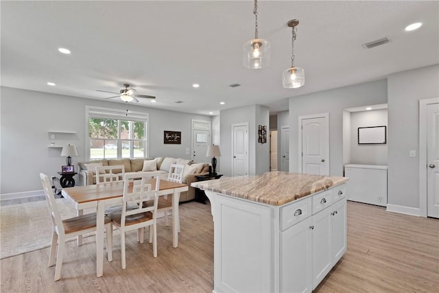 502 Ridge Rd, Darien, GA 31305 - kitchen with light wood-style flooring, white cabinets, a ceiling fan, a kitchen island, and recessed lighting