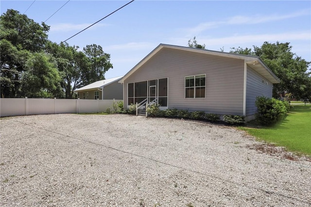 502 Ridge Rd, Darien, GA 31305 - back of house featuring a sunroom and fence