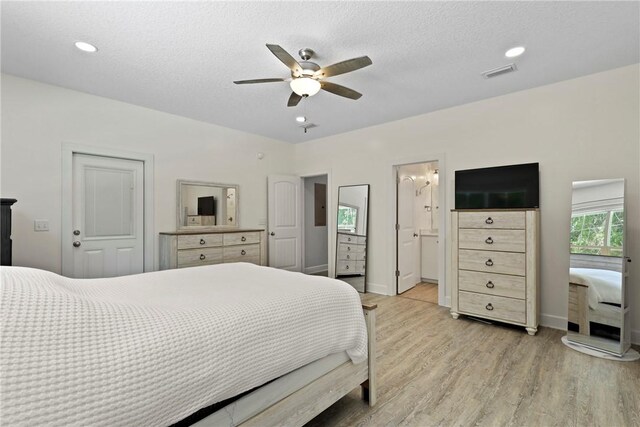 502 Ridge Rd, Darien, GA 31305 - bedroom with light wood finished floors, baseboards, a ceiling fan, a textured ceiling, and ensuite bath