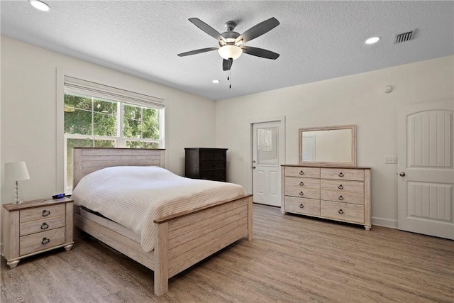 502 Ridge Rd, Darien, GA 31305 - bedroom with light wood-style flooring, a textured ceiling, recessed lighting, a ceiling fan, and baseboards