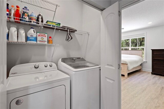 502 Ridge Rd, Darien, GA 31305 - laundry area featuring washing machine and clothes dryer, light wood finished floors, and baseboards