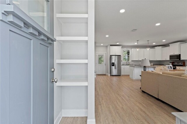 502 Ridge Rd, Darien, GA 31305 - living room with light wood-style floors, recessed lighting, and baseboards