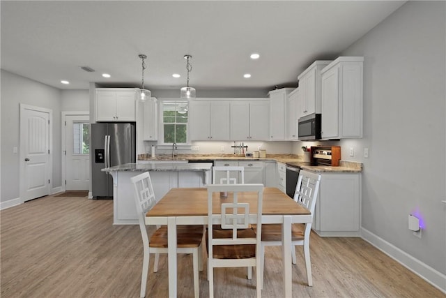 502 Ridge Rd, Darien, GA 31305 - kitchen featuring stainless steel appliances, baseboards, light wood-style floors, white cabinets, and recessed lighting