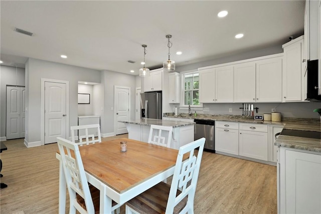 502 Ridge Rd, Darien, GA 31305 - dining room with recessed lighting, light wood finished floors, and baseboards