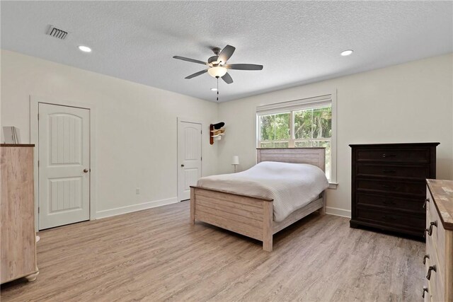 502 Ridge Rd, Darien, GA 31305 - bedroom with light wood finished floors, a textured ceiling, baseboards, recessed lighting, and a ceiling fan