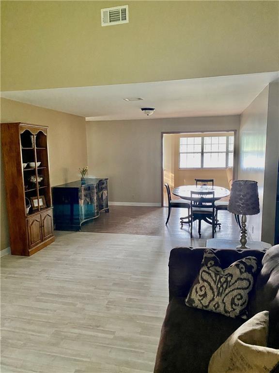 126 Lake View Cir, Brunswick, GA 31525 - living room featuring baseboards and light wood-style floors